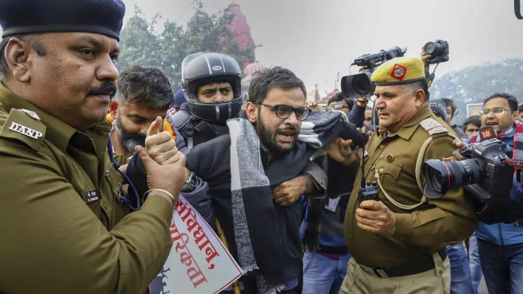 In this file photo dated Dec. 19, 2019, former JNU student and activist Umar Khalid is detained by police for defying prohibitory orders imposed by the Delhi Police in the area during an anti-Citizenship Act protest, at Red Fort, in New Delhi. Khalid was arrested late on Sunday night, Sept 13, 2020, under the Unlawful Activities (Prevention) Act (UAPA) for his alleged role in the northeast Delhi riots. | Photo Credit: PTI