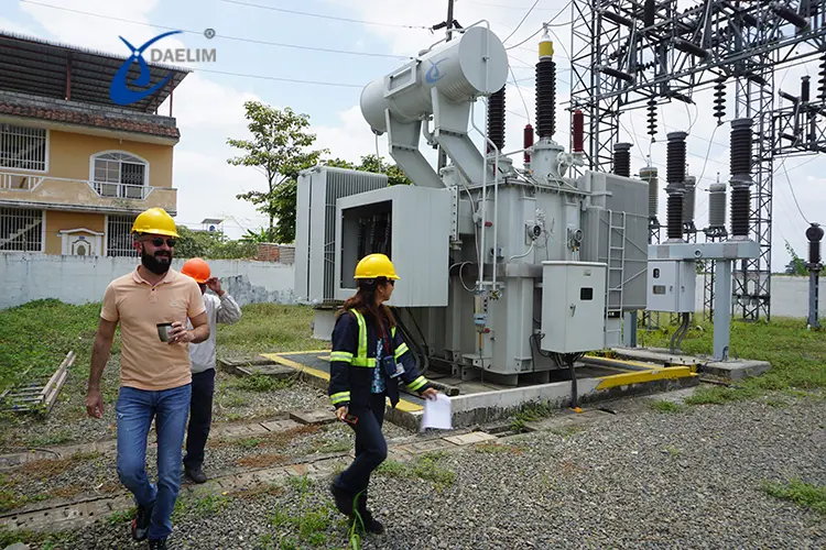 Electrical substation transformer installation work with technicians performing maintenance