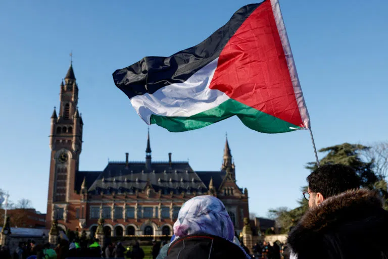 Palestinian flag flies in front of the International Court of Justice building during hearings on the legality of Israeli occupation of Palestinian territories